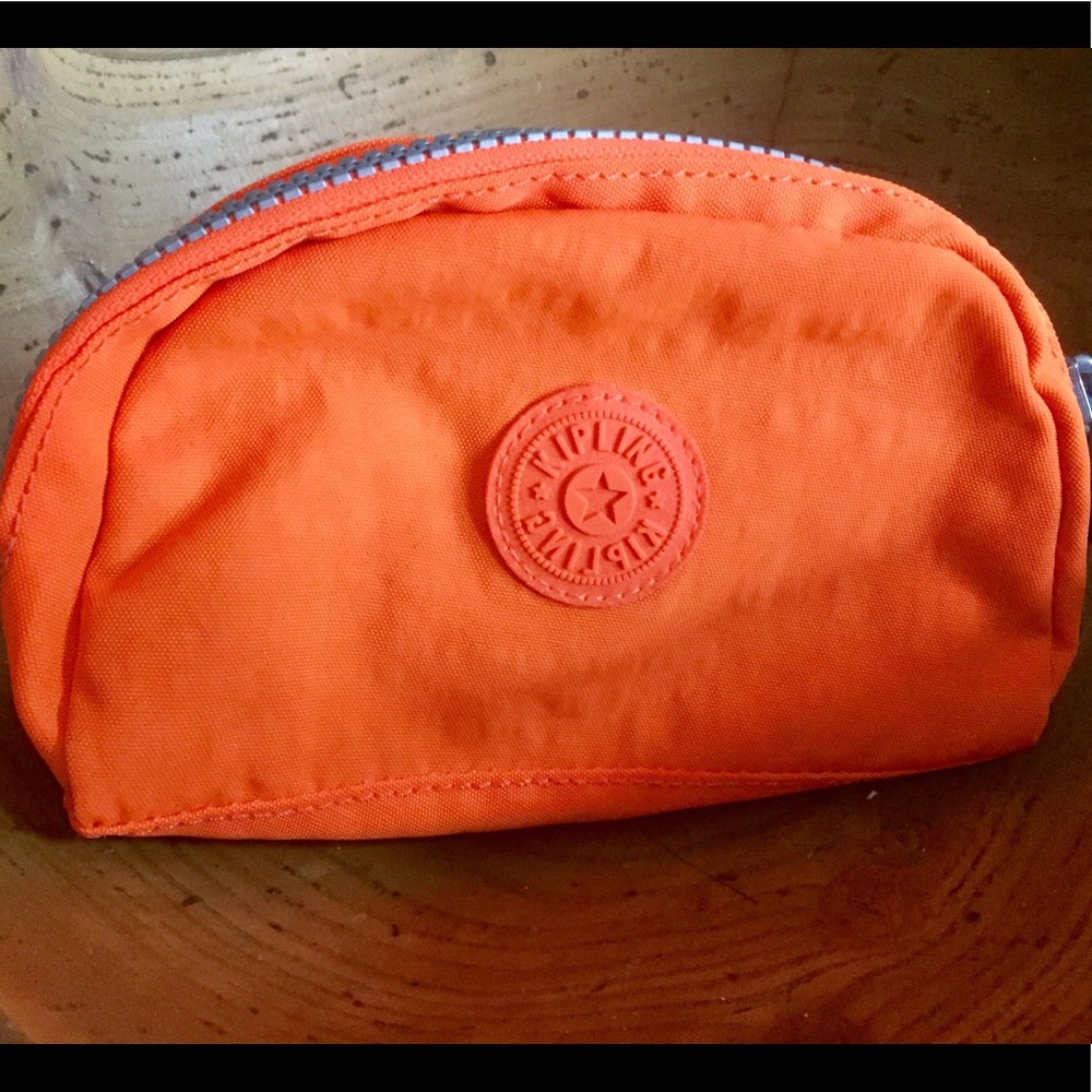 Kipling orange make up case, new.